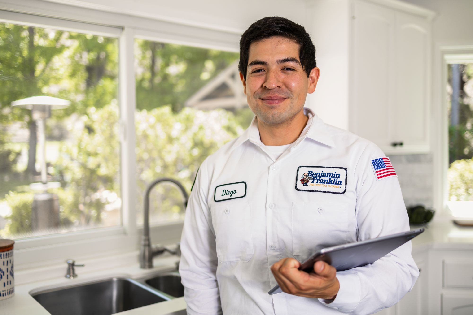Benjamin Franklin Plumbing business technician in branded uniform.